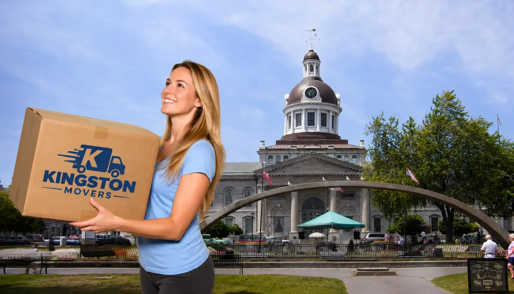 Woman carrying a Kingston Movers moving box in front of Kingston City Hall